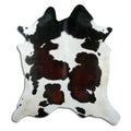 Tricolour cowhide rug of about 220 × 200 cm, seen from above: the exact hide you receive