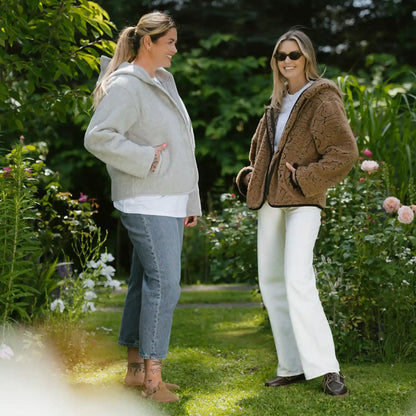 Two women outdoors in Laguna jackets, one grey and one dark brown