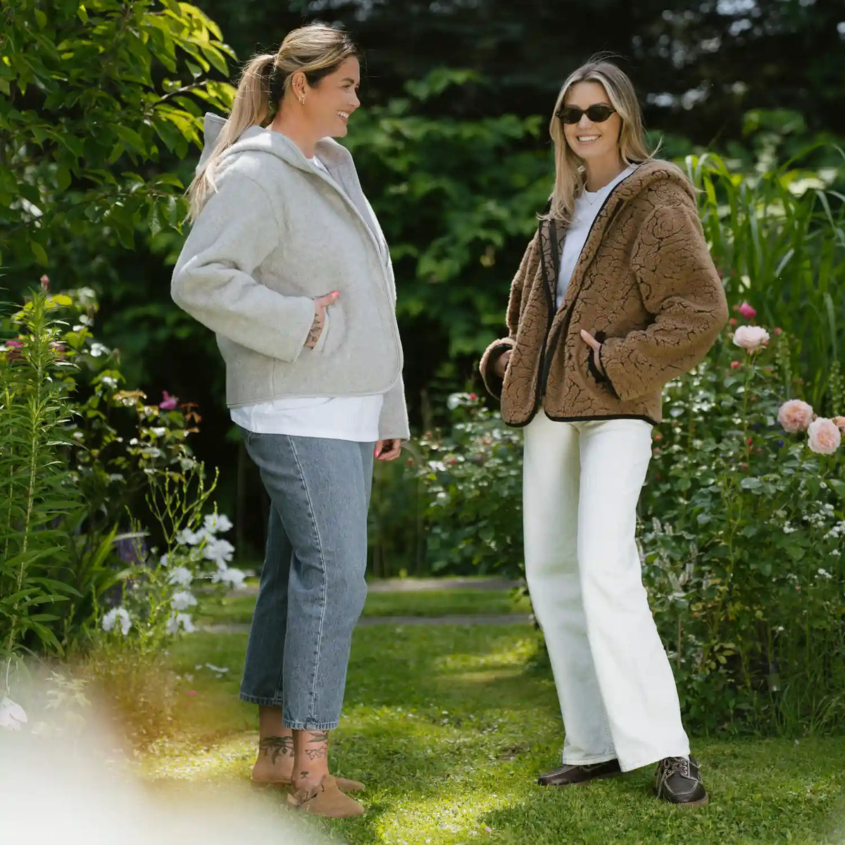 Two women outdoors in Laguna jackets, one grey and one dark brown