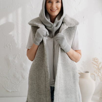 The grey Wave merino vest with the hood up