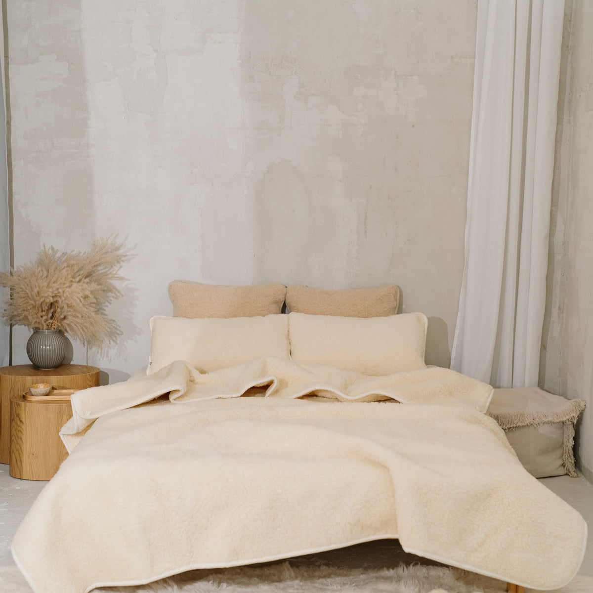 Marzipan merino blanket on a double bed