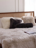 Sheepskin cushions on a bed