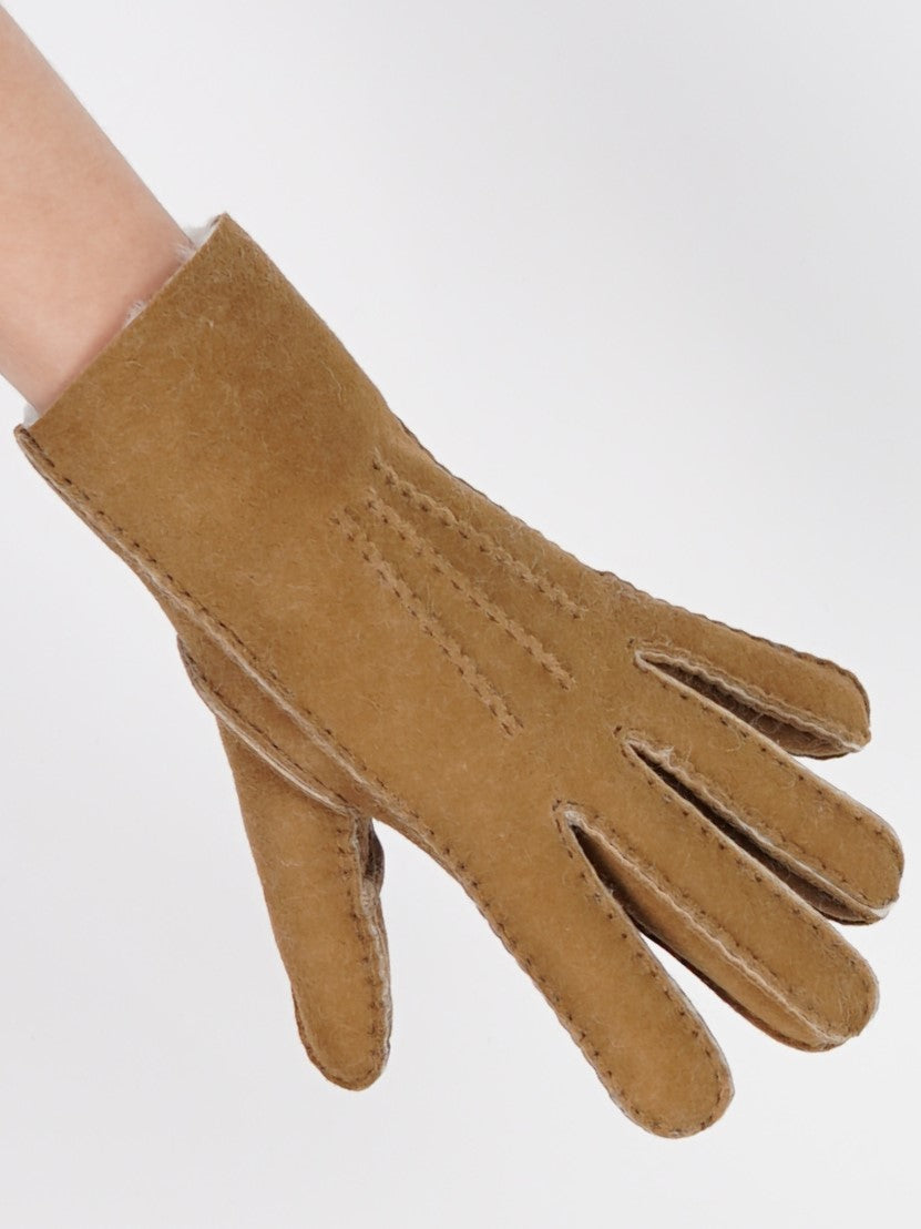 Caramel sheepskin glove worn on the hand