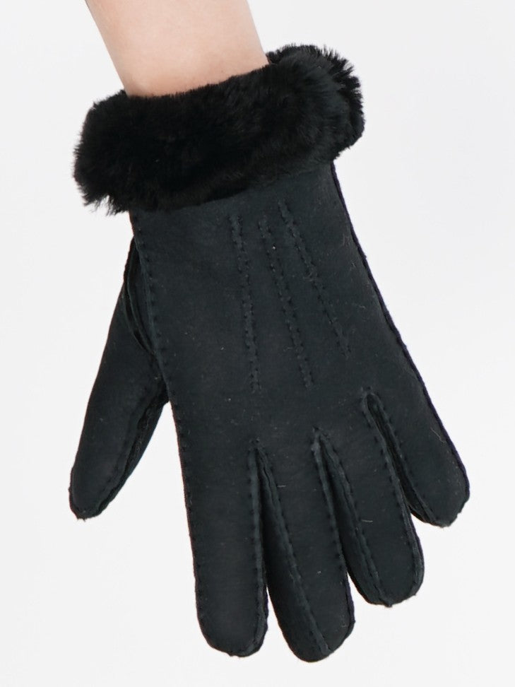 Black sheepskin glove with its folded sheepskin cuff