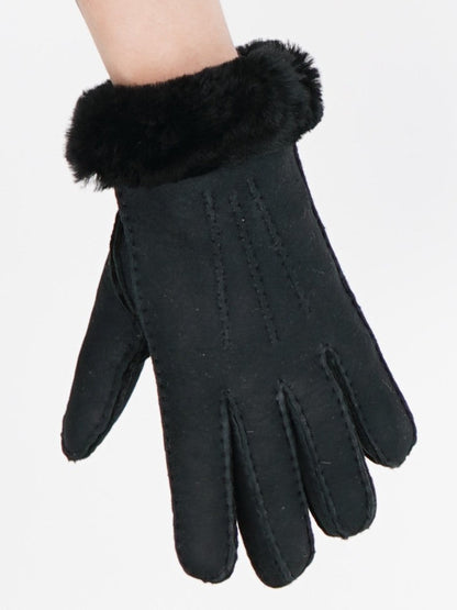Black sheepskin glove with its folded sheepskin cuff
