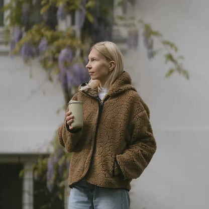 A woman in the dark brown Laguna wool jacket outdoors