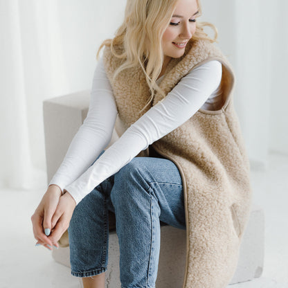 The beige Pearl merino vest worn with a white top and jeans