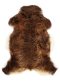 Brown sheepskin rug of about 110 × 70 cm, seen from above: the exact sheepskin you receive