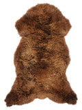 Brown sheepskin rug of about 125 × 65 cm, seen from above: the exact sheepskin you receive