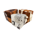 Several patchwork cowhide ottomans together
