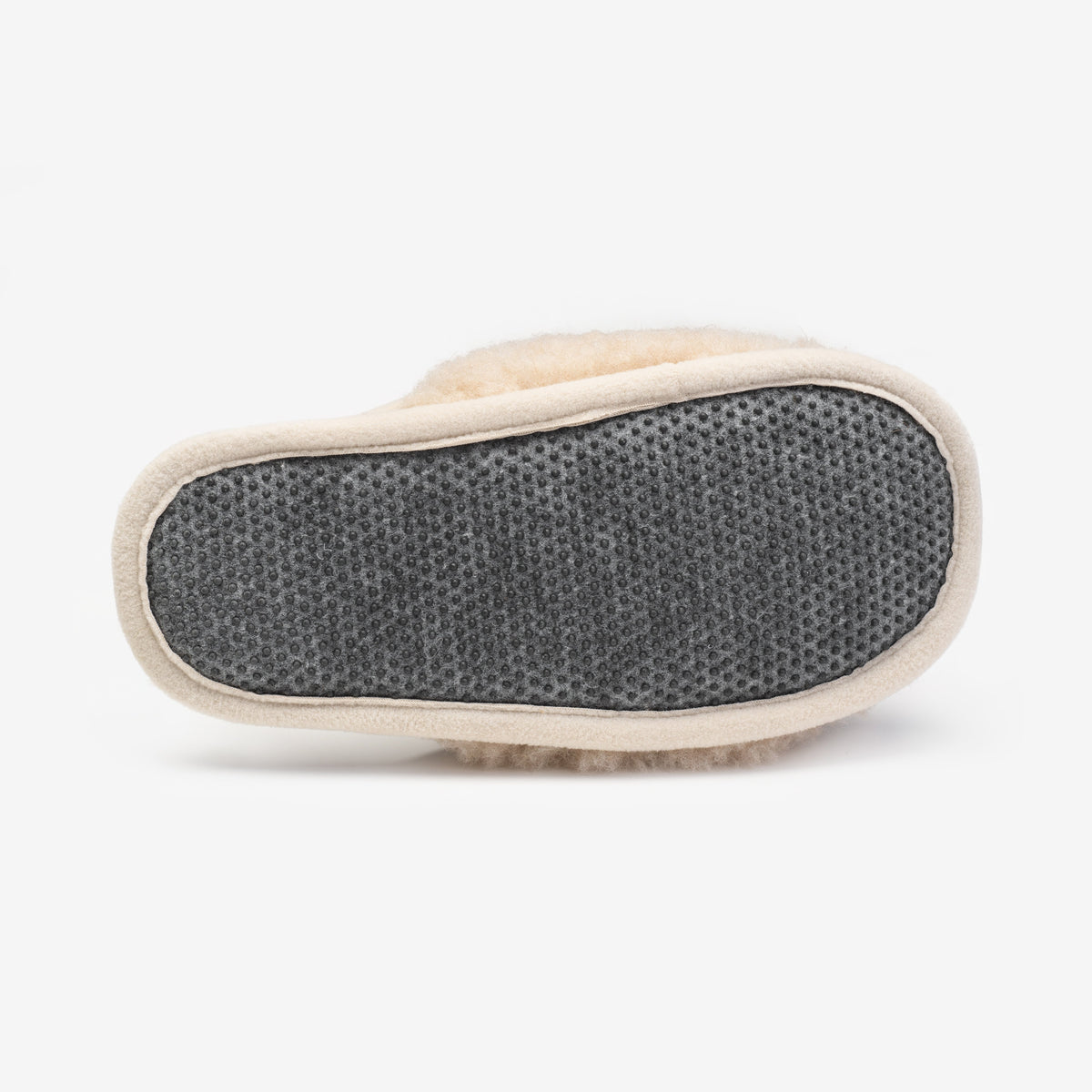 Dotted sole of a beige merino slipper