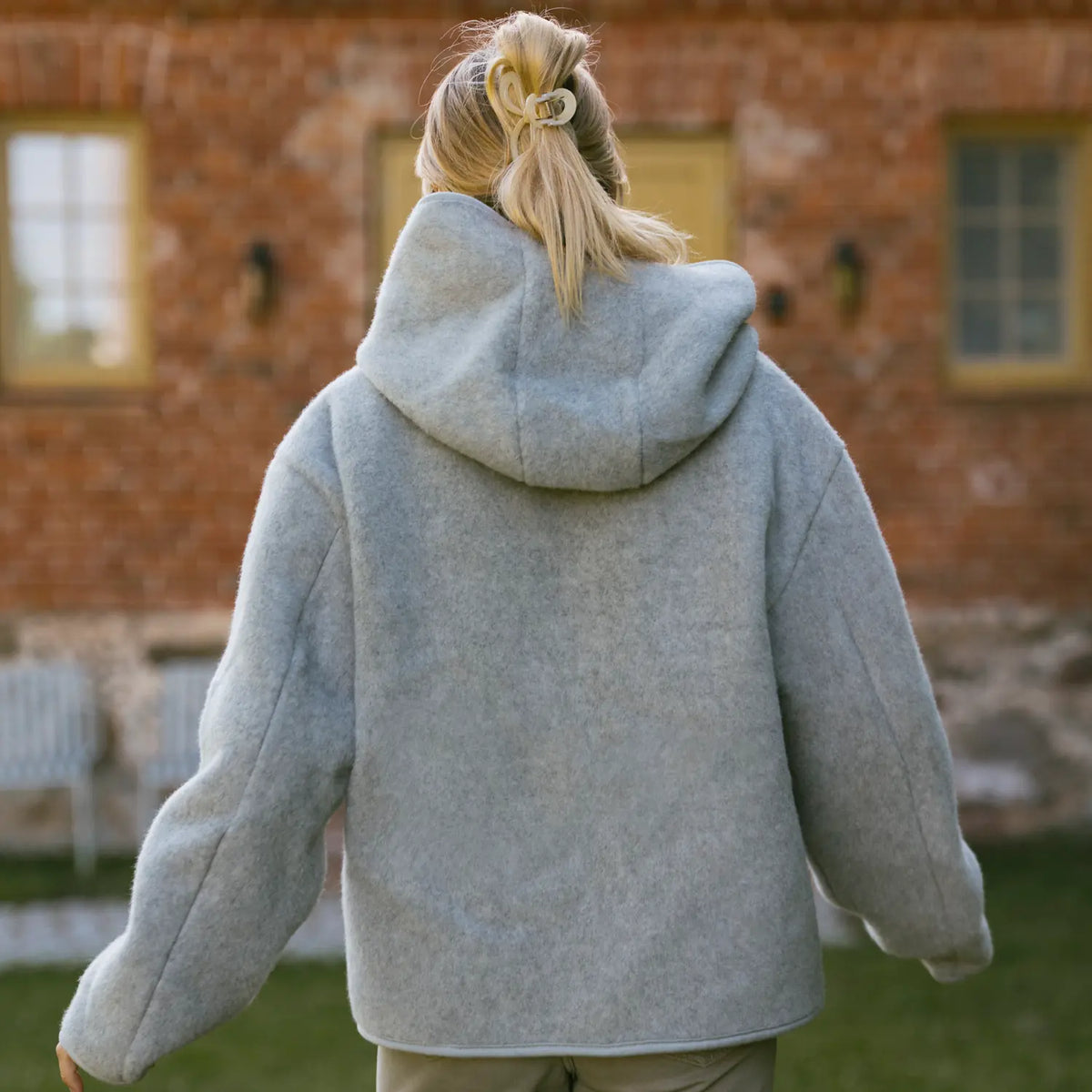 The Laguna merino jacket from behind, worn outdoors