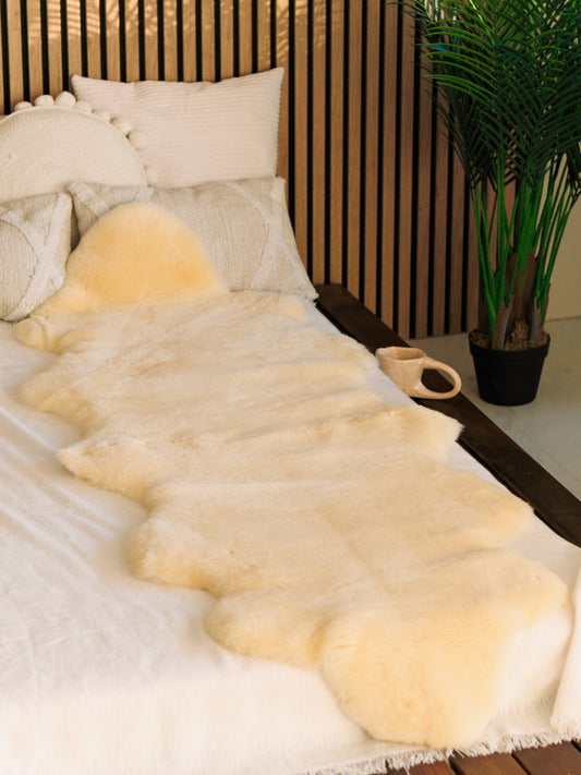 Medical sheepskin bed pad of about 180 × 60 cm on a bed