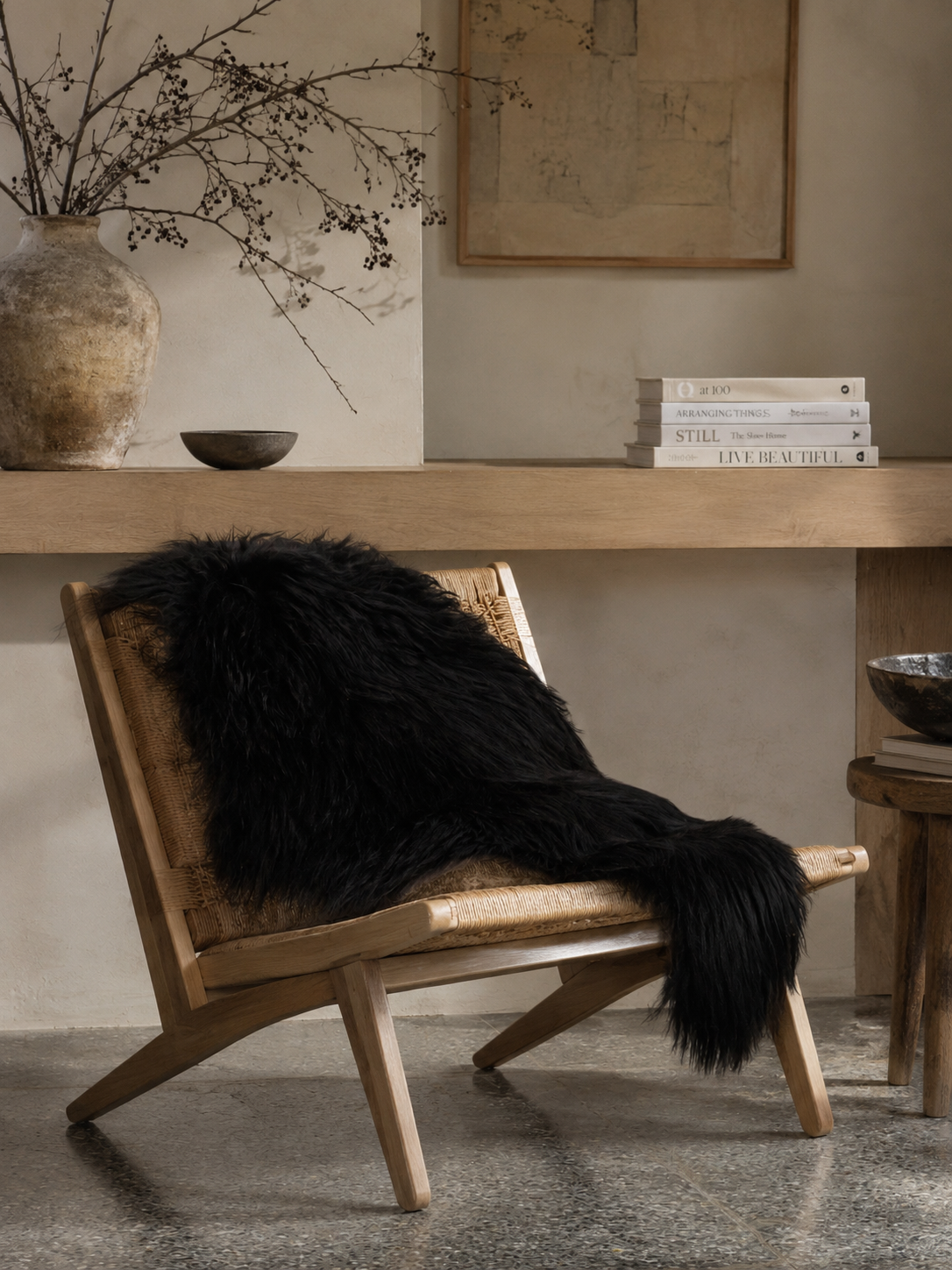 Black Icelandic sheepskin over a low wooden chair