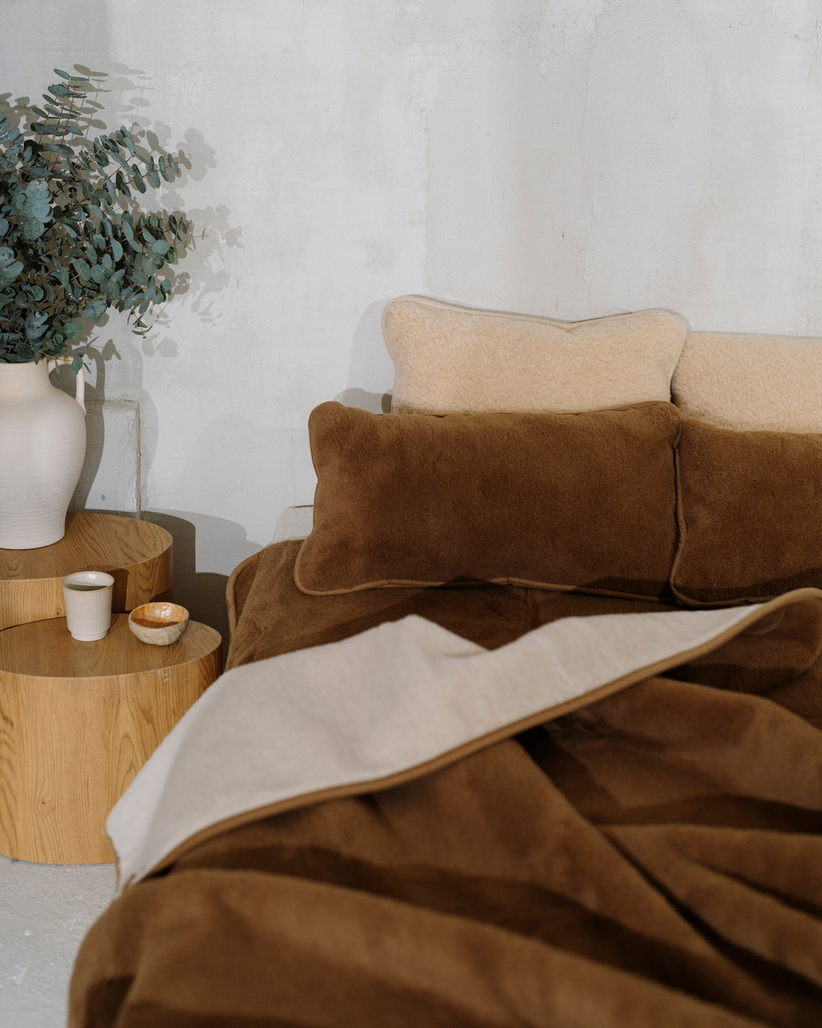 Camel wool blanket turned back on a bed to show its lighter side