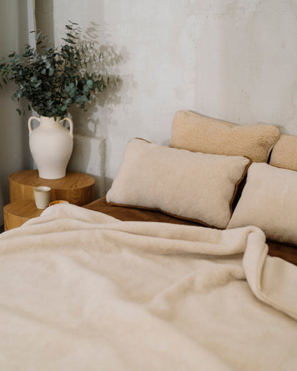 Caramel wool blanket on a bed with wool pillows