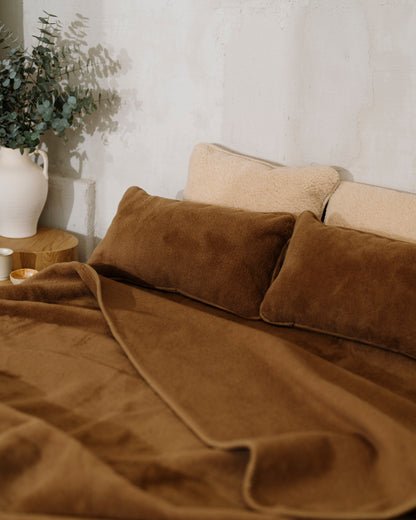 Chocolate wool blanket on a bed