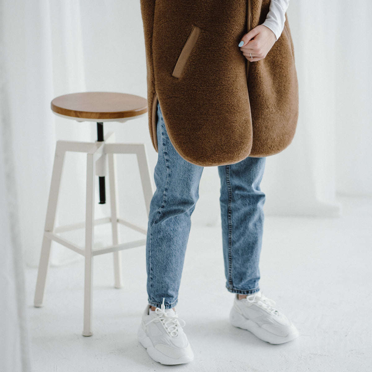 The Pearl vest worn with a hand in the pocket