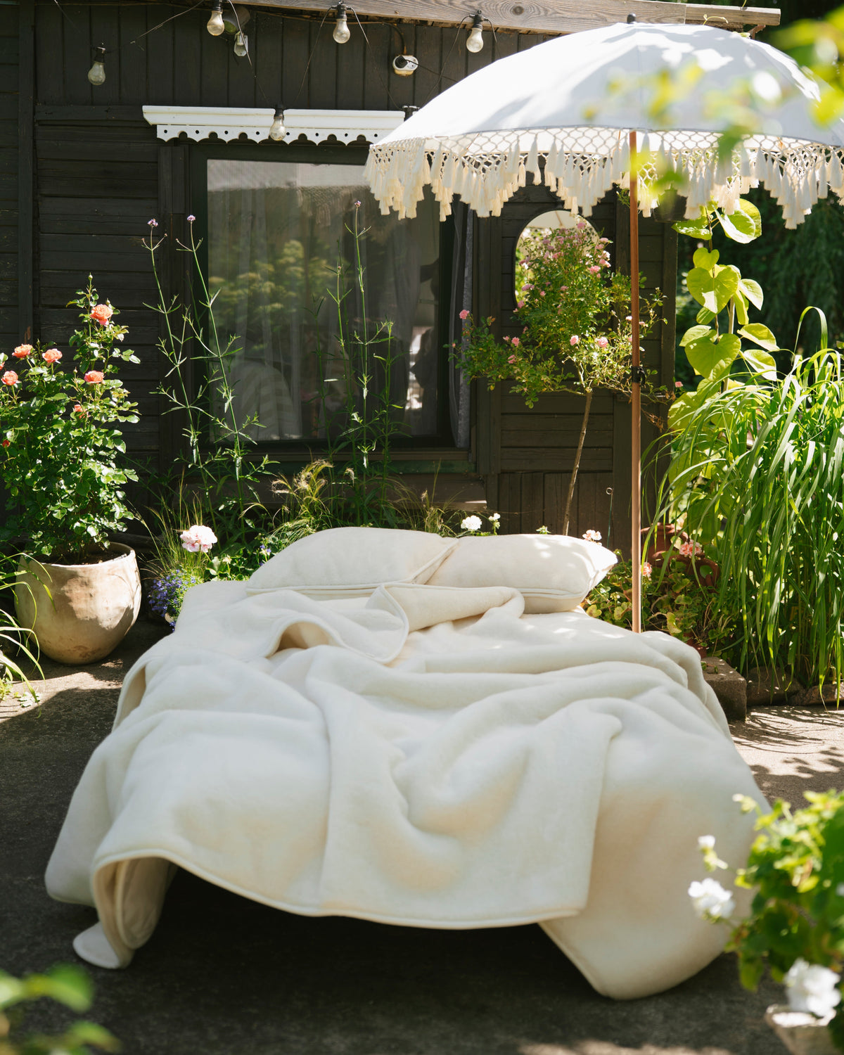 Cashmere wool blanket on a bed set up in a garden