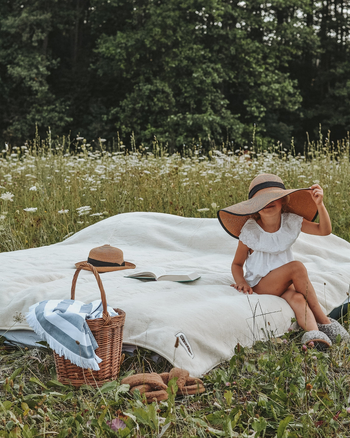 A woman relaxing on the Cashmere wool blanket in a meadow