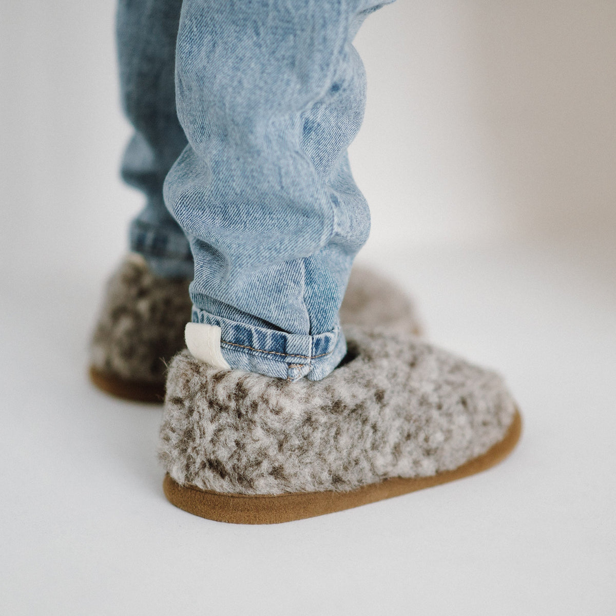Tiger merino slippers worn with jeans, from the side