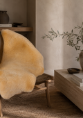 Medical sheepskin draped over a wooden sideboard