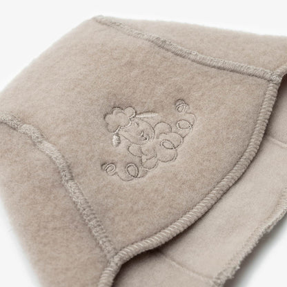 Close-up of the embroidered sheep on the beige merino baby hat