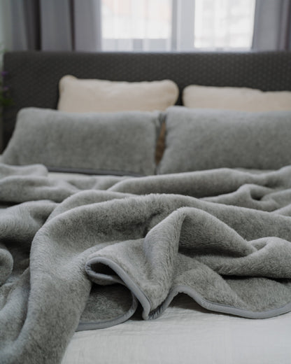 Meringue merino blanket on a bed