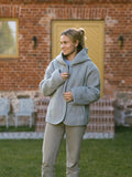 A woman wearing the Laguna merino jacket in grey