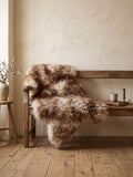 Mouflon sheepskin rug on a wooden bench