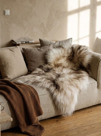 Icelandic mouflon sheepskin over a sofa with cushions