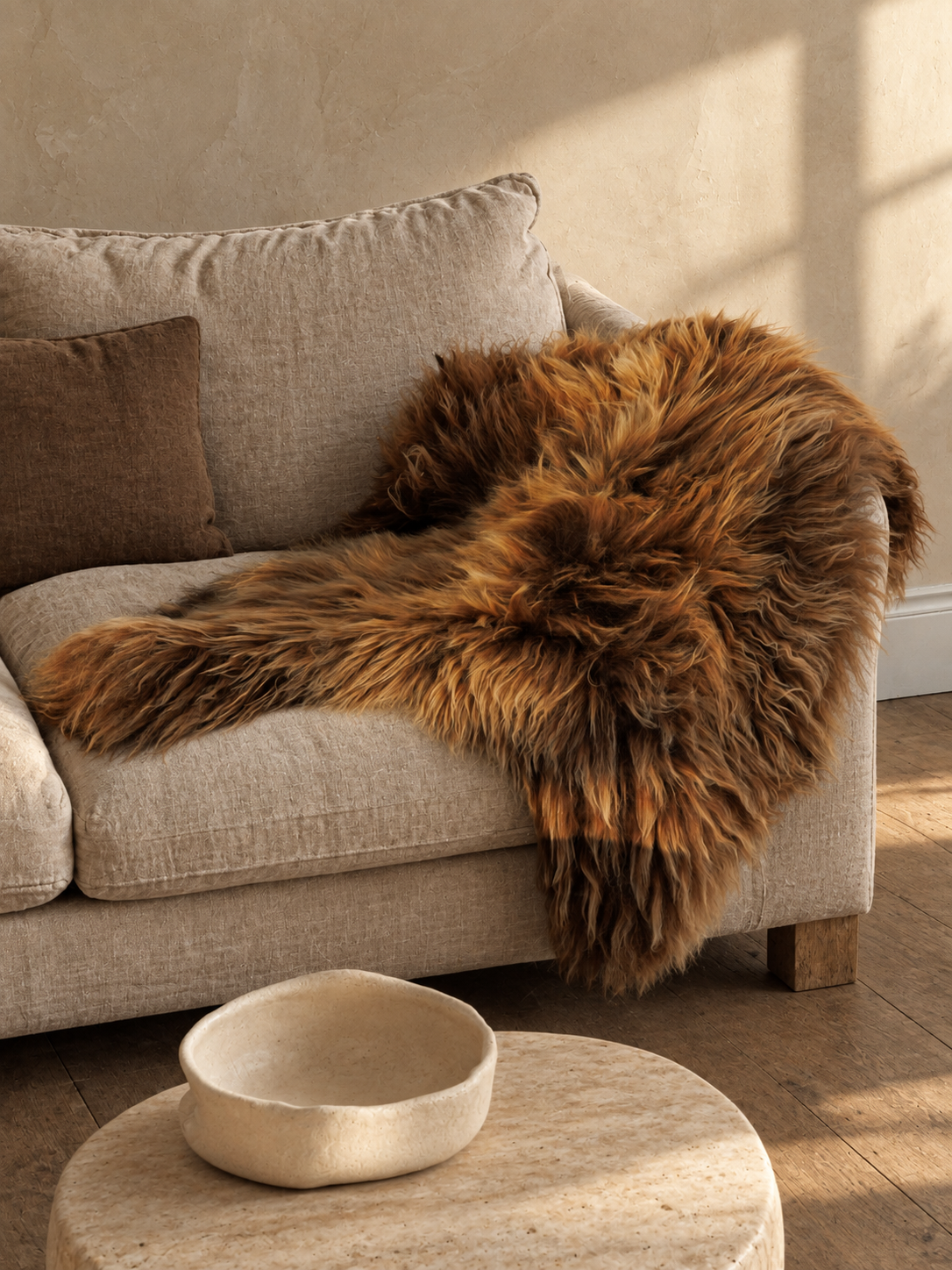 Brown Icelandic sheepskin draped over a sofa