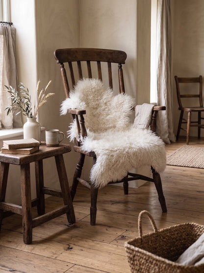 White curly sheepskin over a wooden chair