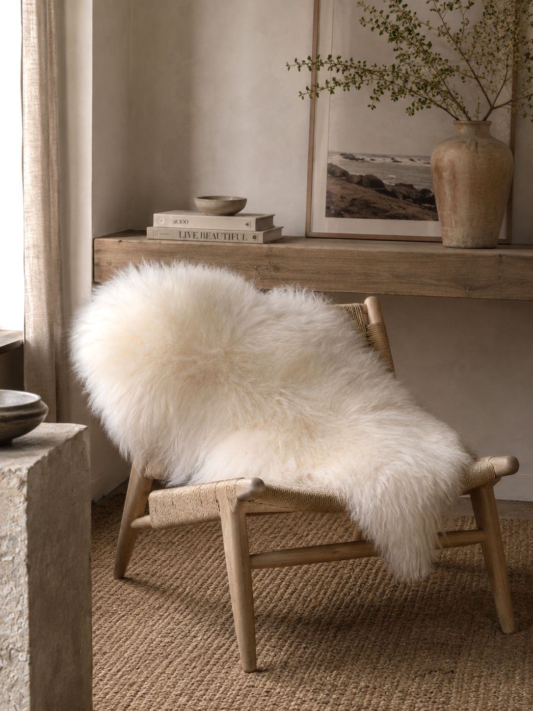 White Icelandic sheepskin over a wooden chair beside a desk
