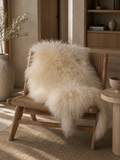 White Icelandic sheepskin draped over a wooden chair